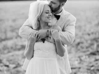 Golden hour black and white bride and groom in field in Illinois by Geneva Wedding Photographer