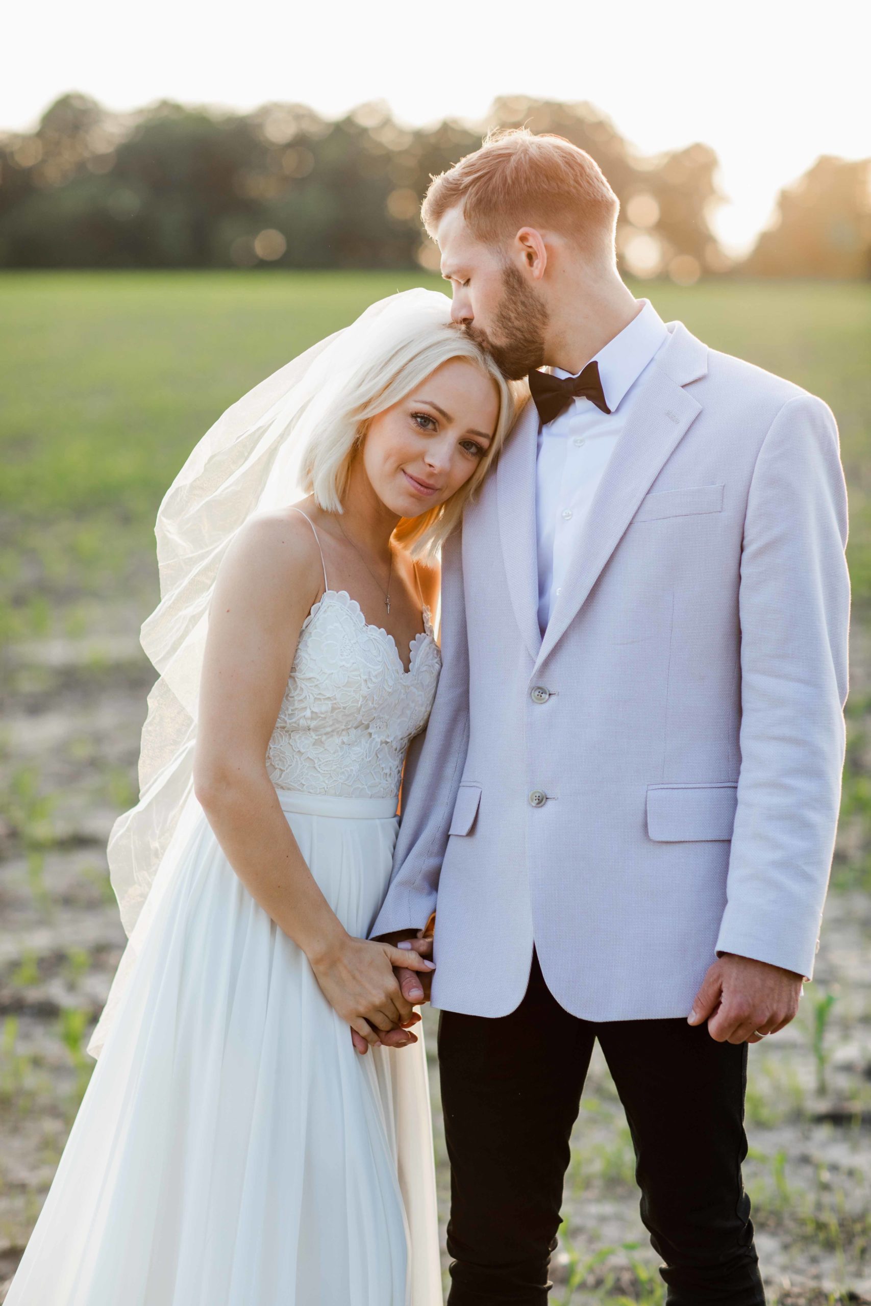 Golden hour bride and groom in field in Illinois by Geneva Wedding Photographer