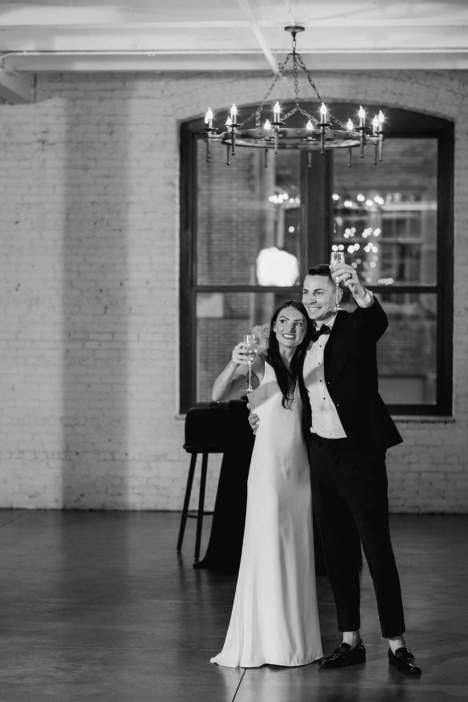 Company 251 Geneva Wedding Photographer black and white of bride and groom during toasts