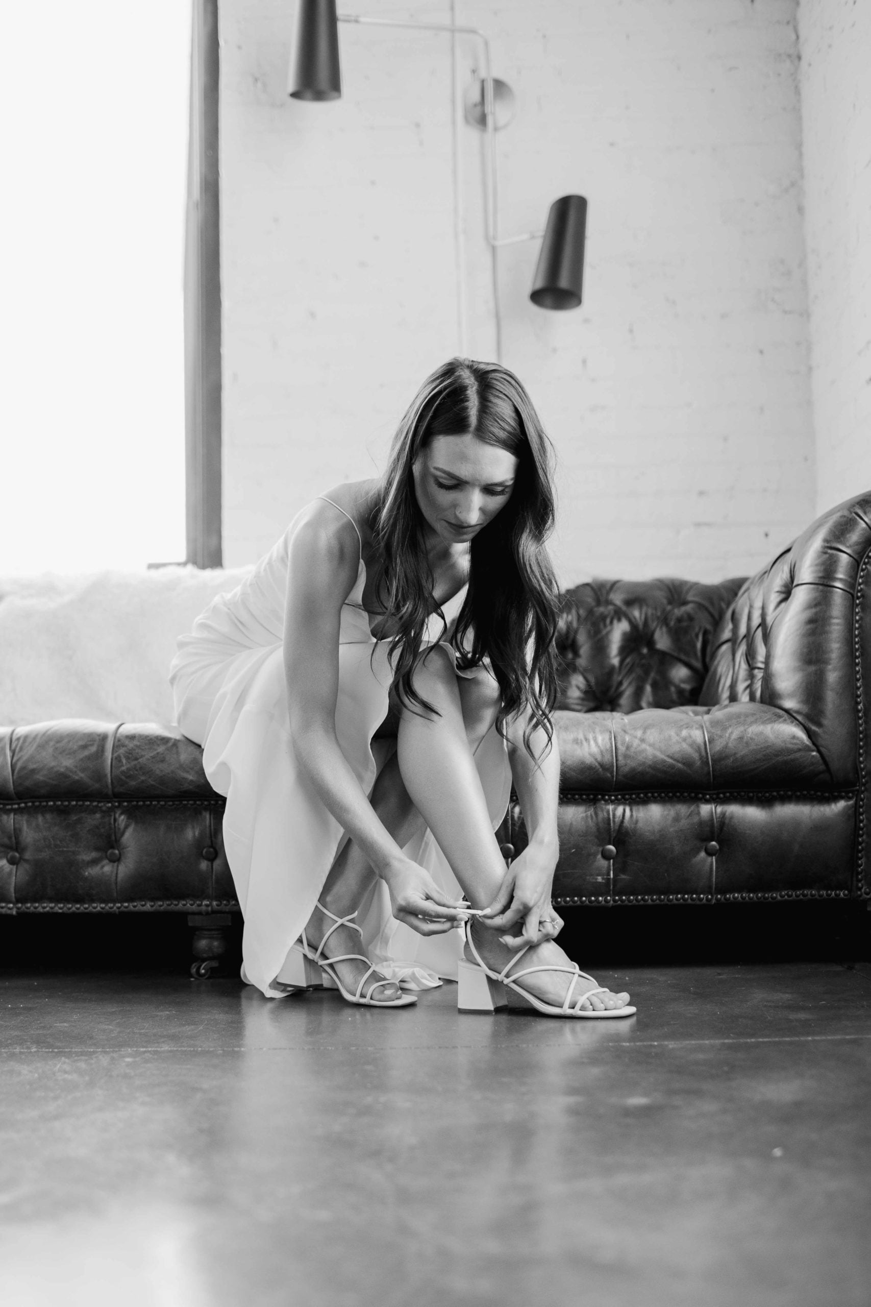 Company 251 Geneva Wedding Photographer black and white of bride putting on her shoes