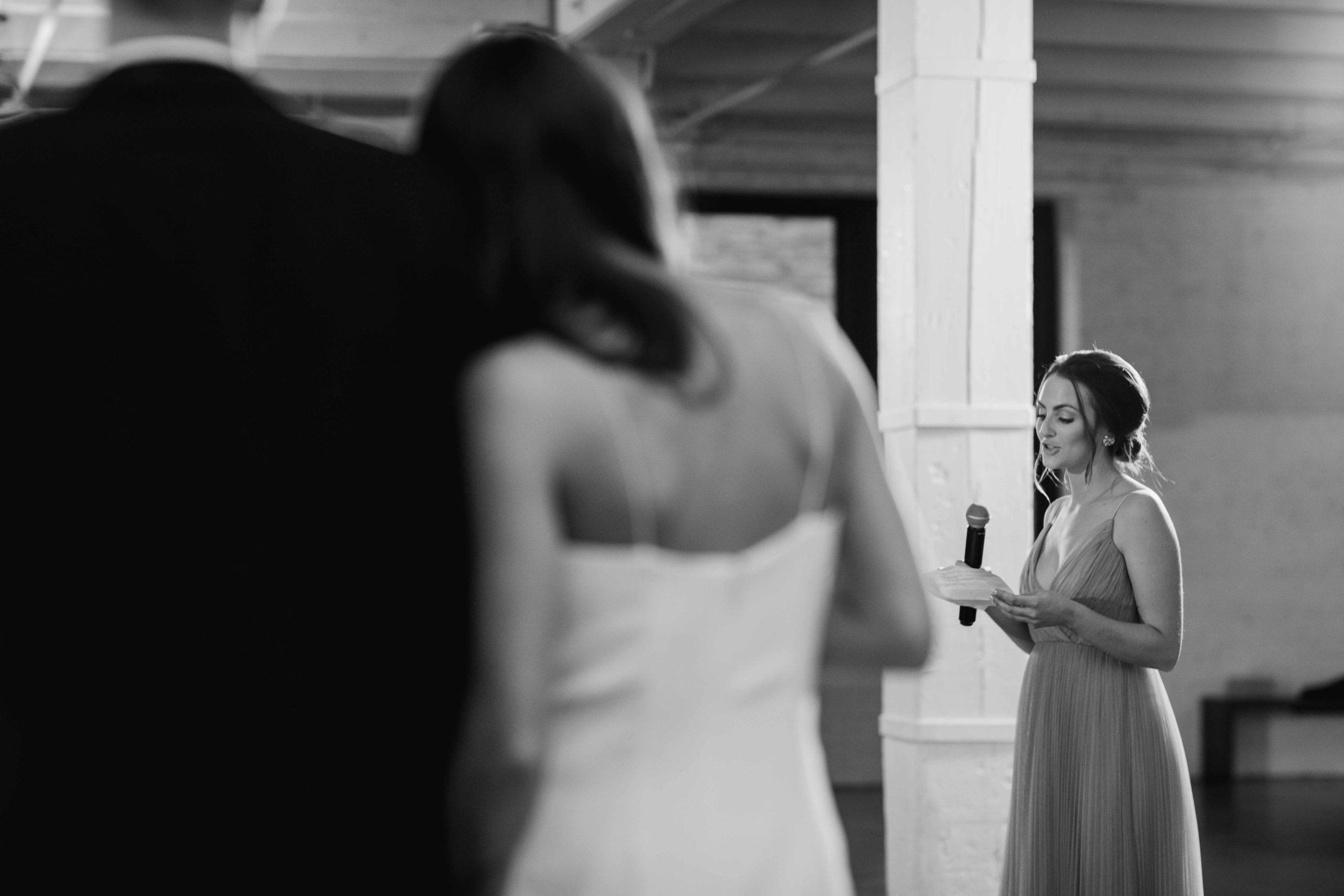 Company 251 Geneva Wedding Photographer maid of honor giving toast with bride and groom in black and white