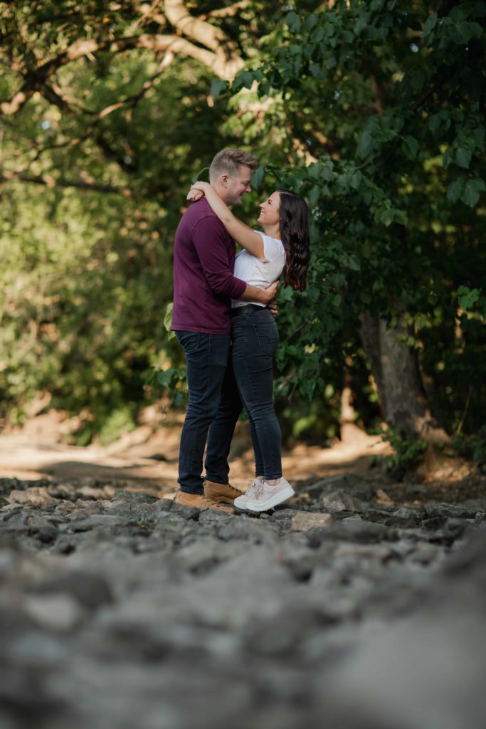 Naperville Riverwalk Engagement Photography in rocks by Illinois Photographer